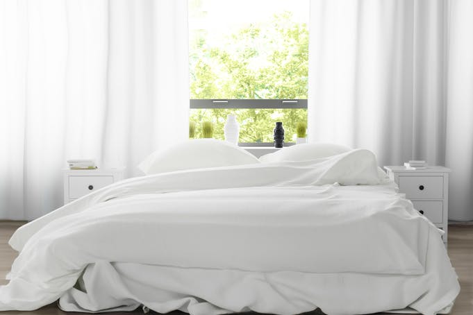 A white-sheeted double bed.